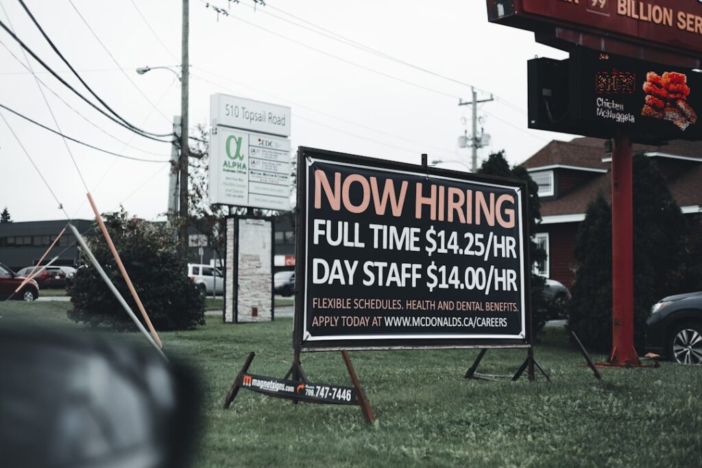 a sign in the grass advertising a job fair