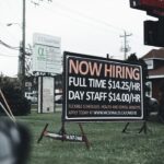 a sign in the grass advertising a job fair